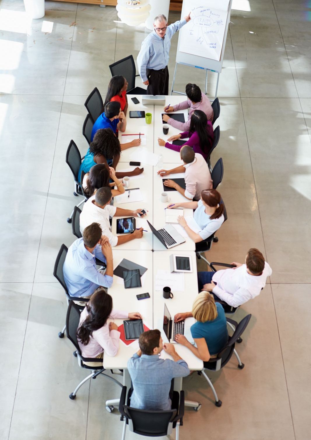 Image of a presenter addressing a larger team